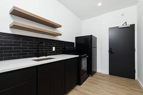 Poughkeepsie apartment for rent - A black fridge and black cupboard in a kitchen.