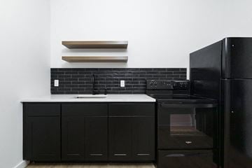 Poughkeepsie apartment for rent - A black oven and cabinet in a kitchen.