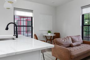 Poughkeepsie apartment for rent - A kitchen with a marble countertop and a brown sofa.