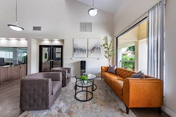Anaheim apartment for rent - A living room with a brown couch and a glass table.