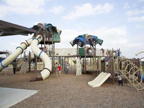 Mcallen apartment for rent - A playground with a slide, swings, and a climbing structure.