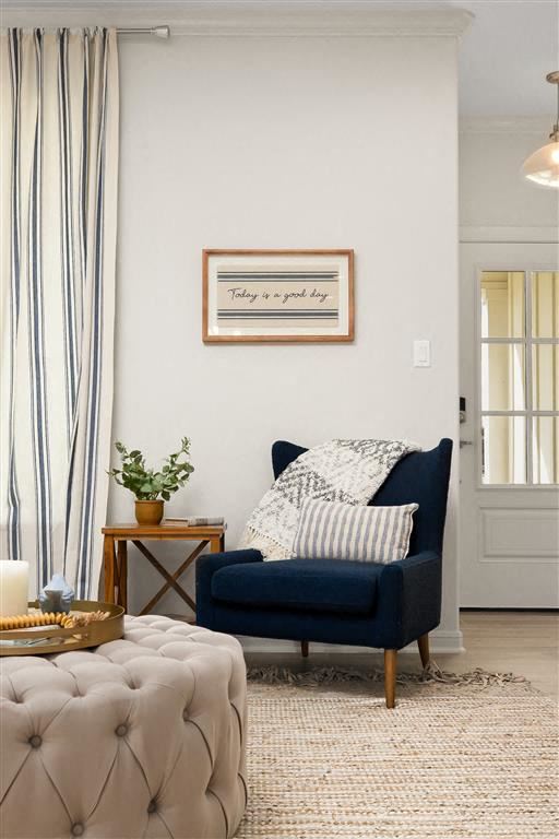 Mcallen apartment for rent - A living room with a blue couch and a framed picture on the wall.
