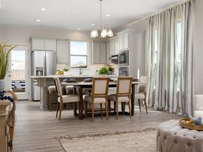 Mcallen apartment for rent - A modern kitchen with a dining table set for four.