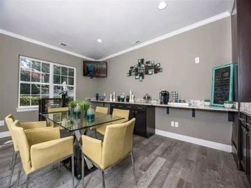 Hoover apartment for rent - A modern kitchen with a glass table and yellow chairs.