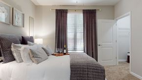Atlanta apartment for rent - A bedroom with a large bed and a window with curtains at Embry Hills, Atlanta, GA, 30042