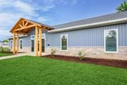 Springfield apartment for rent - A modern house with a wooden porch and grey siding at Poplar Place Apartments, Illinois 62703