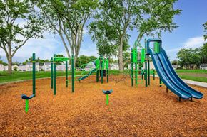 Springfield apartment for rent - A playground with a green slide and a blue slide at Poplar Place Apartments, Springfield
