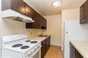 New London apartment for rent - A kitchen with a white stove and a white refrigerator at Mohican Apartments, Connecticut, 06320