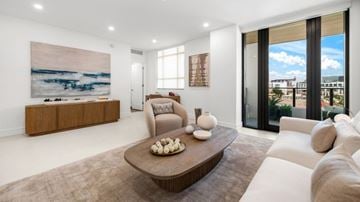 Coral Gables apartment for rent - A living room with a brown coffee table and white couches.