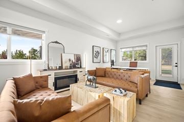 St. Albert apartment for rent - A living room with brown leather couches and a wooden coffee table.