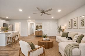 Virginia Beach apartment for rent - A living room with a white couch, a wooden coffee table, and a ceiling fan.