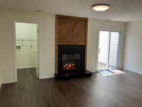 Virginia Beach townhouse for rent - A modern living room with a fireplace and sliding glass doors.
