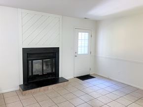 Virginia Beach townhouse for rent - A room with a fireplace and a door.