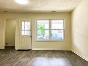 Chesapeake townhouse for rent - A room with a white door, a window, and a wooden floor.