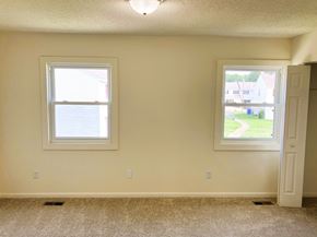 Chesapeake townhouse for rent - A room with a window and a door leading to a view of a street.
