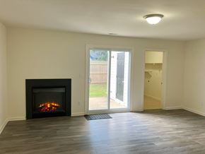 Virginia Beach townhouse for rent - A room with a fireplace and sliding glass doors.