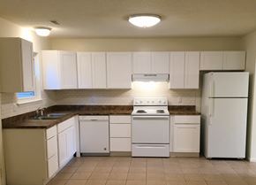 Virginia Beach townhouse for rent - A kitchen with white appliances and cabinets.