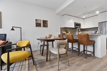 Surrey apartment for rent - A modern kitchen with a dining table and chairs.