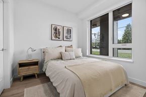 Surrey apartment for rent - A bedroom with a large bed and two pictures on the wall.