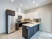 Edmonton apartment for rent - A modern kitchen with a stainless steel refrigerator and a white countertop.