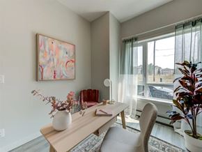Edmonton apartment for rent - A dining room with a table, chairs, and a painting on the wall.