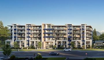 Surrey apartment for rent - A large apartment complex with a parking lot in front.
