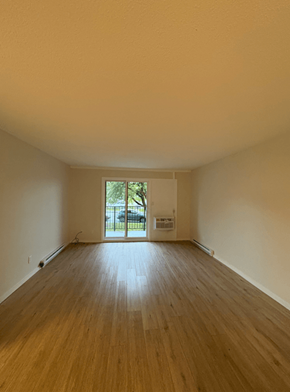 Courtenay apartment for rent - A room with wooden floors and a door leading outside.