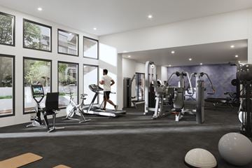Surrey apartment for rent - A man is working out on a treadmill in a spacious gym with various exercise equipment.