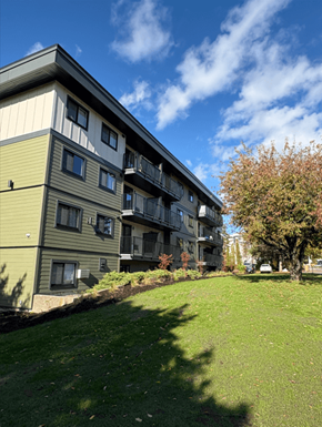 Courtenay apartment for rent - A building with a green lawn in front of it.