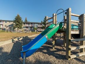 Prince George apartment for rent - A blue and green slide in a playground.