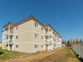 Prince George apartment for rent - A large beige apartment building with multiple balconies and windows.