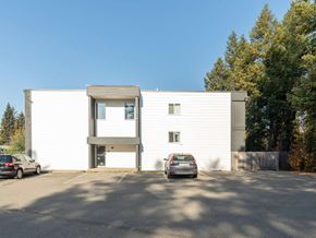 Prince George apartment for rent - A modern white building with a car parked in front.