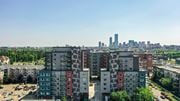 Edmonton apartment for rent - A cityscape with apartment buildings in the foreground and a city skyline in the background.