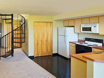Cleveland triplex for rent - A kitchen with a white refrigerator and a black stove top oven.
