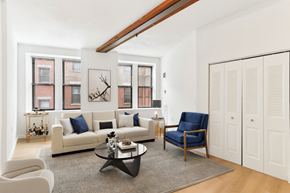 Dorchester apartment for rent - A living room with a white couch, a blue chair, and a coffee table.