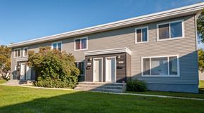 Edmonton townhouse for rent - A grey house with a white door and windows.