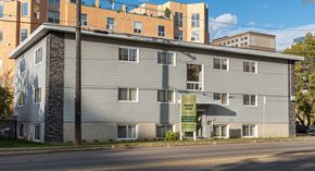 Edmonton apartment for rent - A building with a sign that says "For Sale" in front of it.
