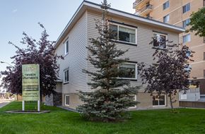Edmonton apartment for rent - A sign for Twinson Apartments is in front of a building.