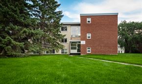 Edmonton apartment for rent - A red brick building with a white door and windows.