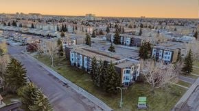 Edmonton apartment for rent - A view of a residential area with apartment buildings and trees.