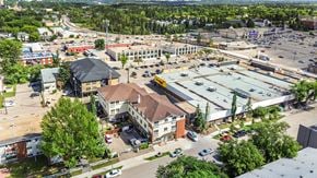 Edmonton apartment for rent - A parking lot is surrounded by buildings in the image.