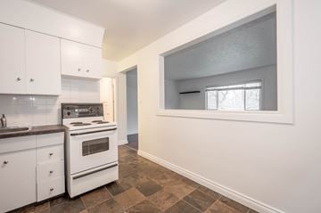 Edmonton apartment for rent - A kitchen with white cabinets and a tiled floor.