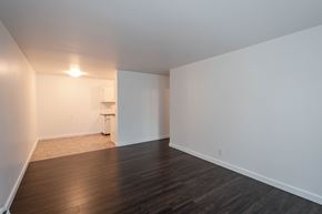 Edmonton apartment for rent - A room with a wooden floor and white walls.