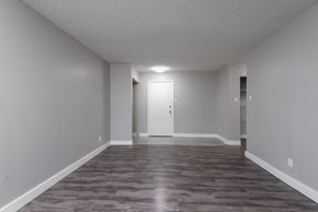 Edmonton apartment for rent - A room with a wooden floor and a white door.