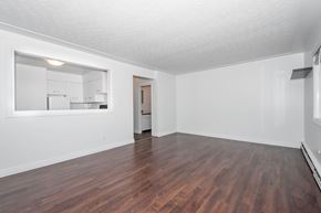 Edmonton apartment for rent - A room with wooden floors and white walls.