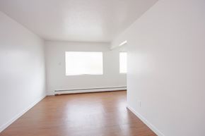 Edmonton apartment for rent - A room with wooden floors and a window.