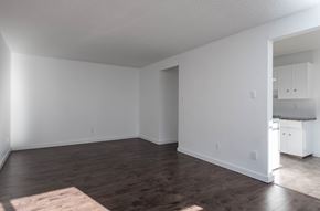 Edmonton apartment for rent - A room with wooden floors and white walls.