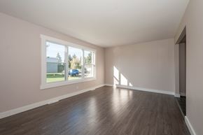 Edmonton townhouse for rent - A room with wooden floors and a large window.