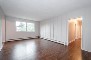 Edmonton apartment for rent - A room with wooden floors and white walls.