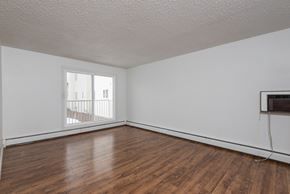 Edmonton apartment for rent - A room with wooden floors and a window.